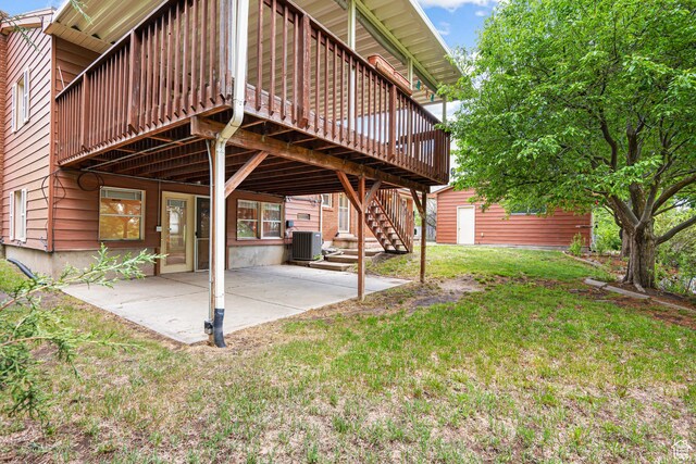 4115 Edgehill Dr, Ogden, UT 84403 - view of green lawn with a wooden deck, a patio area, an outbuilding, central AC, and stairway