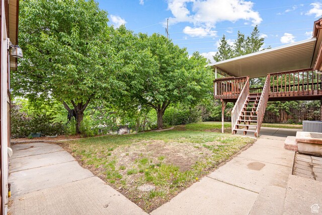 4115 Edgehill Dr, Ogden, UT 84403 - view of grassy yard featuring stairs, cooling unit, a deck, and a patio area