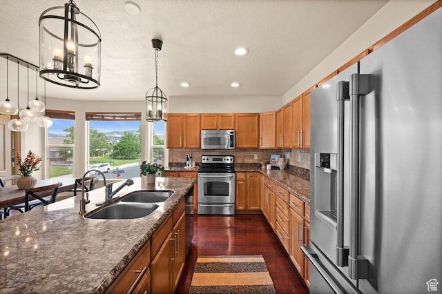 3702 S Arbroath Ln, South Salt Lake, UT 84115 - kitchen featuring appliances with stainless steel finishes, a sink, a chandelier, recessed lighting, and dark wood-style floors