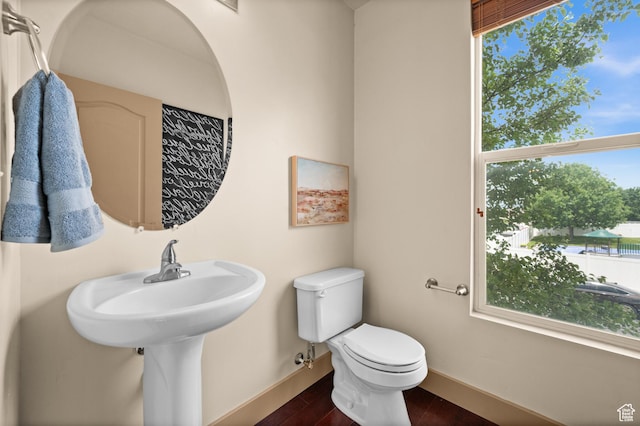 3702 S Arbroath Ln, South Salt Lake, UT 84115 - half bath featuring baseboards, toilet, and wood finished floors