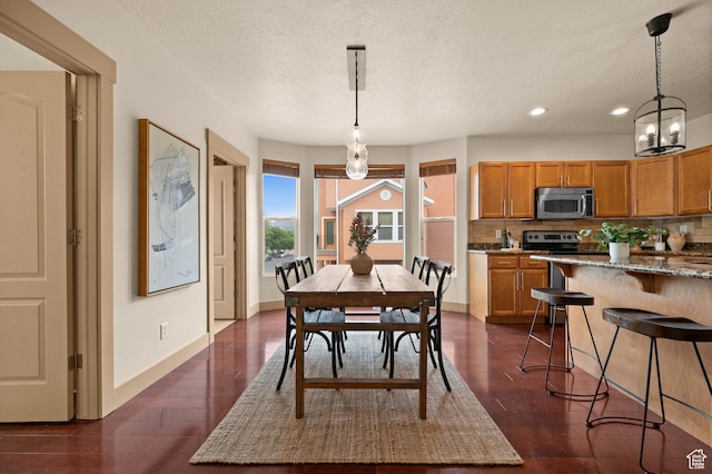 3702 S Arbroath Ln, South Salt Lake, UT 84115 - dining space with recessed lighting, dark wood-style floors, a chandelier, baseboards, and a textured ceiling