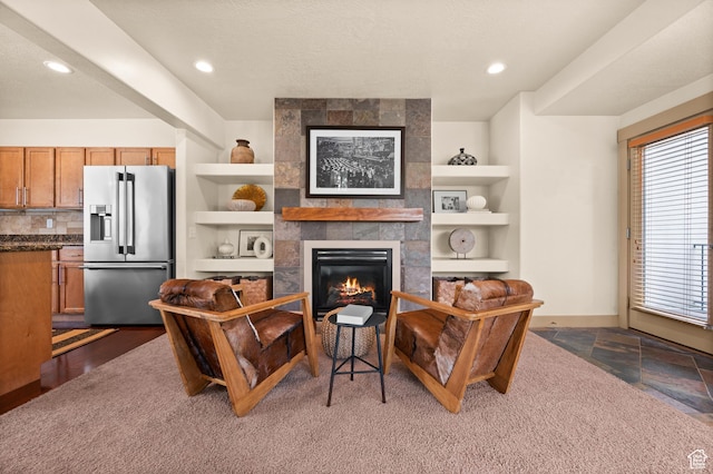 3702 S Arbroath Ln, South Salt Lake, UT 84115 - living room featuring built in shelves, a tile fireplace, and recessed lighting