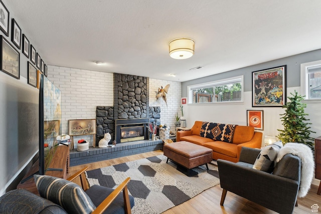 32 S Kingdon Ln E, North Salt Lake, UT 84054 - living area with wood finished floors, a brick fireplace, and a textured ceiling
