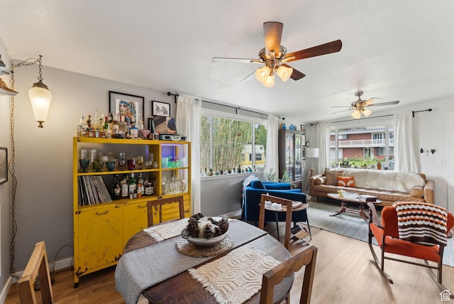 32 S Kingdon Ln E, North Salt Lake, UT 84054 - dining area with light wood-style flooring, healthy amount of natural light, ceiling fan, and baseboards