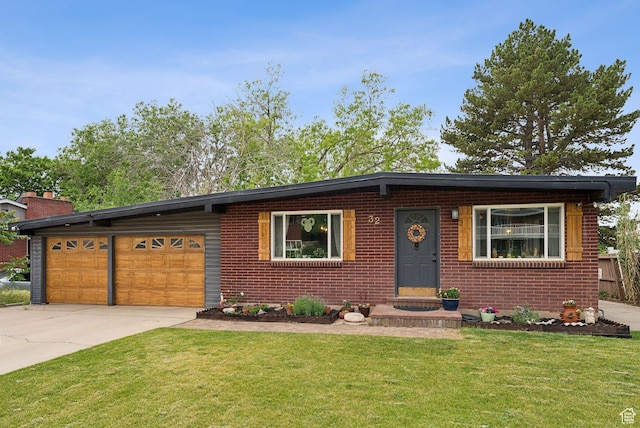 32 S Kingdon Ln E, North Salt Lake, UT 84054 - view of front of house with a front yard, driveway, brick siding, and an attached garage
