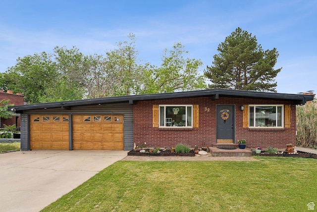 32 S Kingdon Ln E, North Salt Lake, UT 84054 - view of front facade featuring driveway, a front yard, brick siding, and a garage