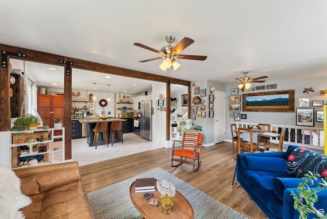 32 S Kingdon Ln E, North Salt Lake, UT 84054 - living area featuring ceiling fan, light wood-style floors, and baseboards