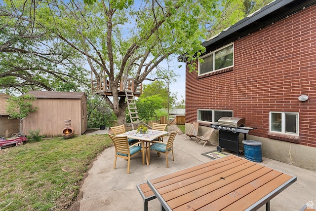 32 S Kingdon Ln E, North Salt Lake, UT 84054 - view of patio with a shed, outdoor dining area, an outbuilding, and area for grilling