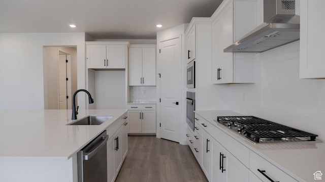 906 W Fallow Dr S Unit 213, Saratoga Springs, UT 84045 - kitchen featuring wall chimney exhaust hood, appliances with stainless steel finishes, tasteful backsplash, white cabinets, and recessed lighting
