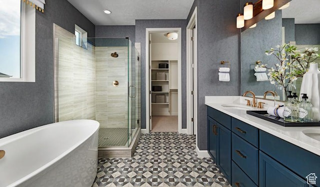 full bath featuring plenty of natural light, a stall shower, a freestanding bath, and double vanity