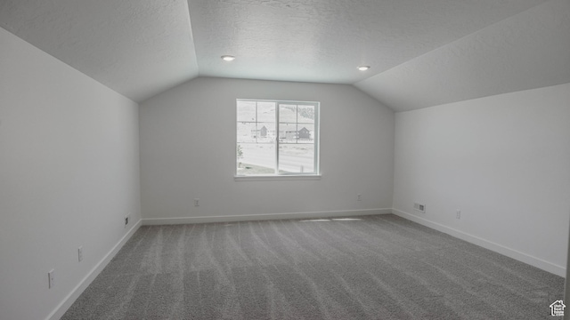 906 W Fallow Dr S Unit 213, Saratoga Springs, UT 84045 - additional living space featuring lofted ceiling, a textured ceiling, and carpet