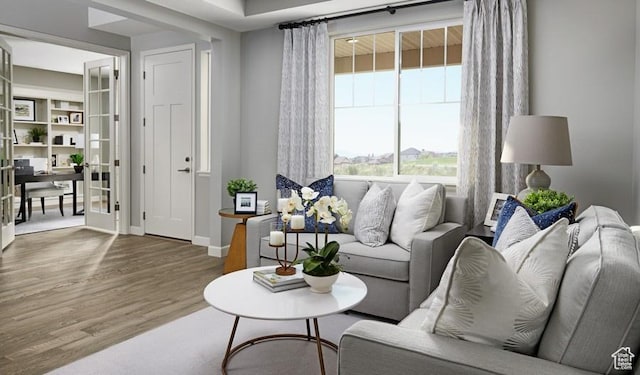 living room featuring a desk, wood finished floors, and baseboards