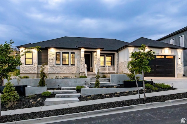 14943 S Auburn Sky Dr Unit 129, Draper, UT 84020 - view of front facade with stone siding, concrete driveway, a garage, and a porch
