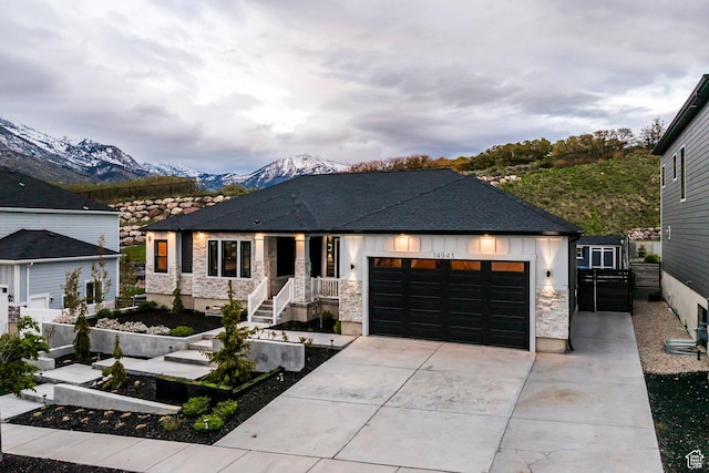 14943 S Auburn Sky Dr Unit 129, Draper, UT 84020 - view of front of property with an attached garage, a mountain view, driveway, and stone siding