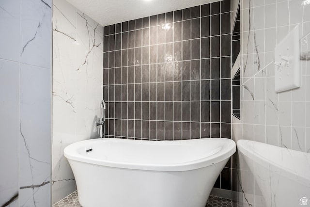 14943 S Auburn Sky Dr Unit 129, Draper, UT 84020 - full bathroom featuring tile walls and a soaking tub