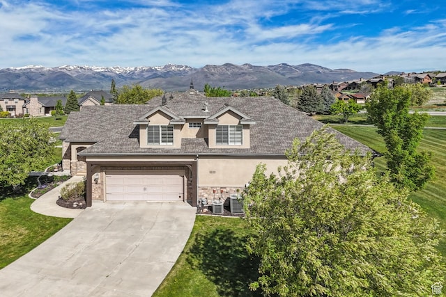 view of front of property with stucco siding, stone siding, concrete driveway, and a garage