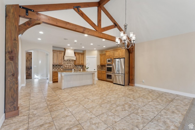 kitchen with stainless steel appliances, custom exhaust hood, arched walkways, backsplash, and recessed lighting