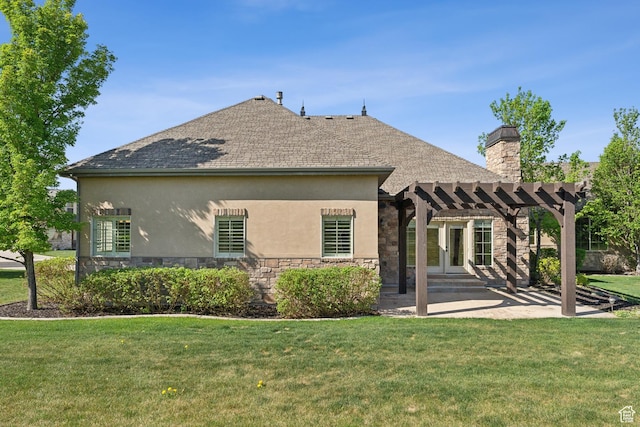 back of property featuring a pergola, stone siding, stucco siding, and a lawn