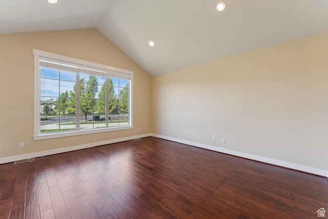 empty room with lofted ceiling, dark wood-style flooring, baseboards, and recessed lighting