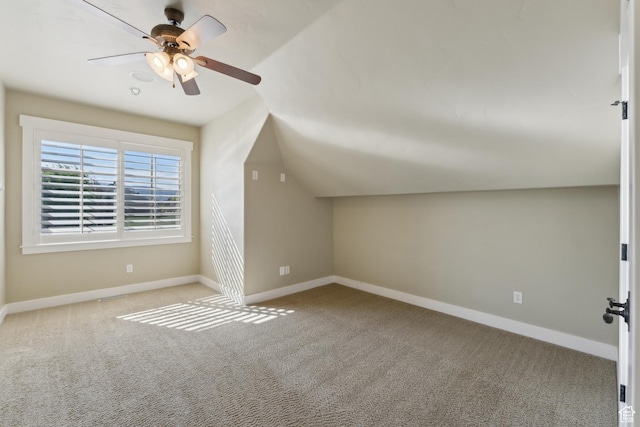 additional living space with carpet flooring, a ceiling fan, baseboards, and lofted ceiling