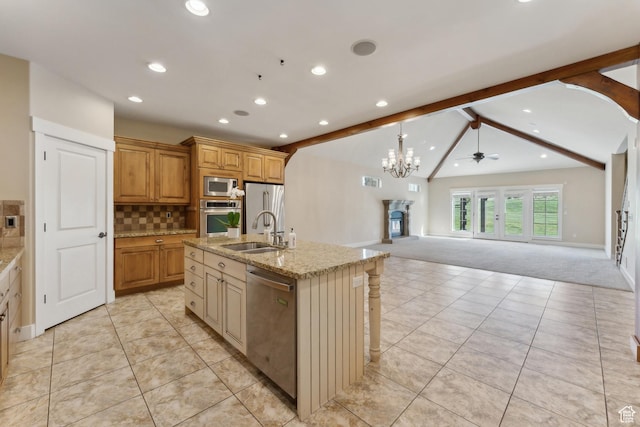 kitchen with stainless steel appliances, a sink, light carpet, recessed lighting, and open floor plan