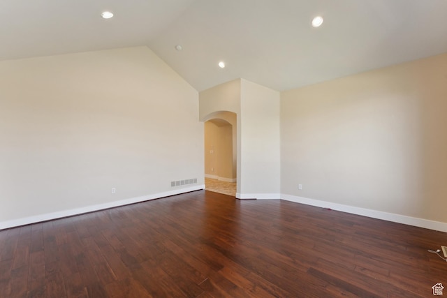 unfurnished room with arched walkways, baseboards, recessed lighting, wood finished floors, and lofted ceiling