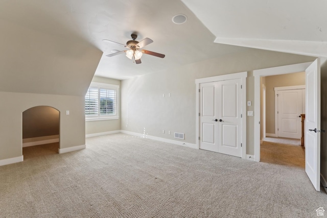 bonus room with a ceiling fan, vaulted ceiling, baseboards, and carpet floors