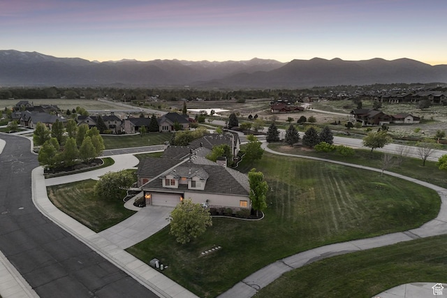 view of property's community featuring driveway, a mountain view, and a residential view