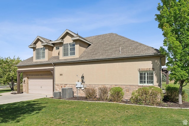view of side of home featuring stucco siding, stone siding, concrete driveway, a lawn, and central air condition unit