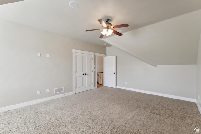additional living space featuring a ceiling fan, baseboards, carpet flooring, and lofted ceiling