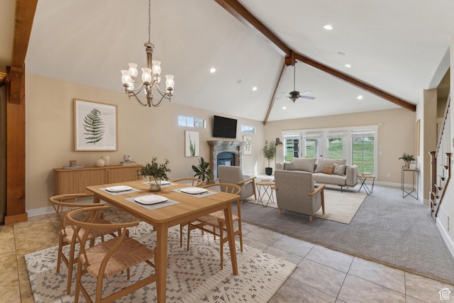 dining area with beamed ceiling, a fireplace, light carpet, baseboards, and light tile patterned flooring