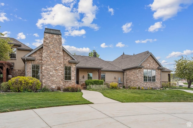 view of front of house with stone siding and a front lawn