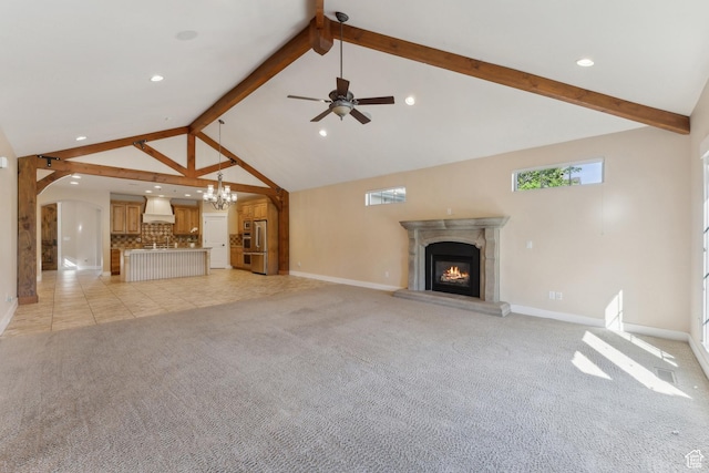 unfurnished living room featuring beamed ceiling, a glass covered fireplace, light carpet, baseboards, and high vaulted ceiling