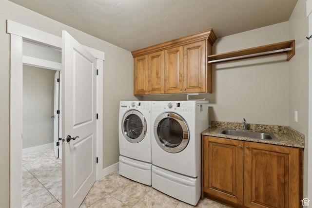 laundry room featuring washer and clothes dryer, cabinet space, baseboards, and light marble finish floors