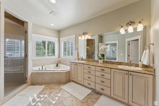 bathroom with a shower stall, a garden tub, double vanity, and tile patterned floors