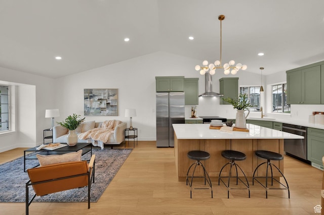 1128 N 850 E, Pleasant Grove, UT 84062 - kitchen featuring green cabinetry, stainless steel appliances, wall chimney range hood, light countertops, and vaulted ceiling