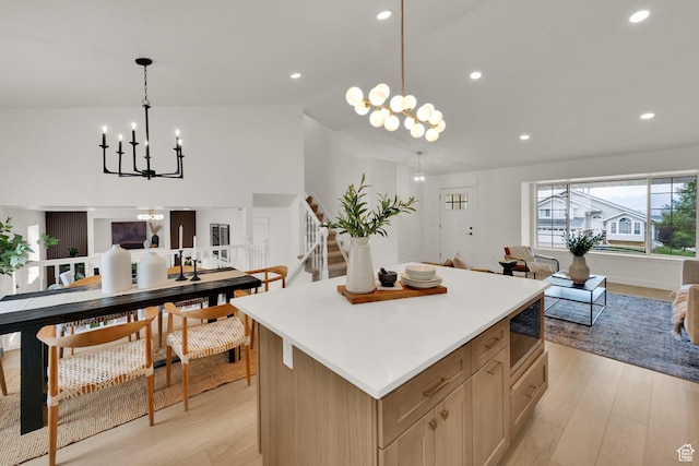 1128 N 850 E, Pleasant Grove, UT 84062 - kitchen featuring a chandelier, open floor plan, built in microwave, a kitchen island, and light wood-style flooring