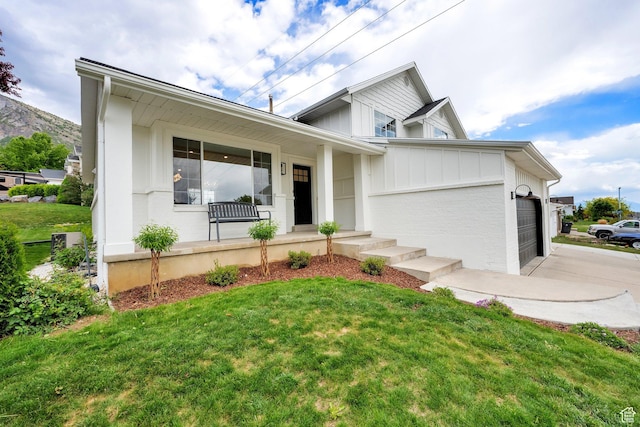 1128 N 850 E, Pleasant Grove, UT 84062 - view of front of property with an attached garage, a porch, a front yard, and board and batten siding