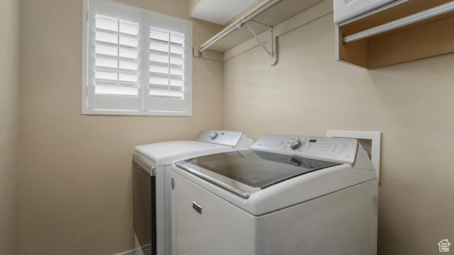 clothes washing area featuring independent washer and dryer