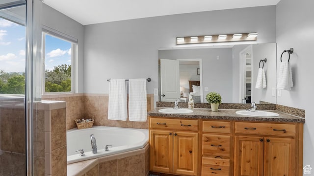 ensuite bathroom with a garden tub and double vanity