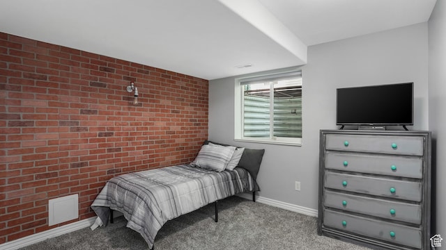 bedroom featuring brick wall, carpet flooring, an accent wall, and baseboards