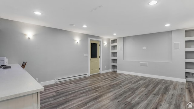 unfurnished living room featuring baseboard heating, built in features, recessed lighting, wood finished floors, and baseboards