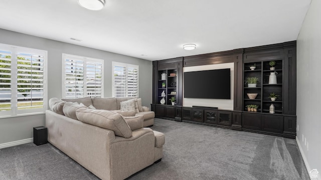 carpeted living room with baseboards and healthy amount of natural light