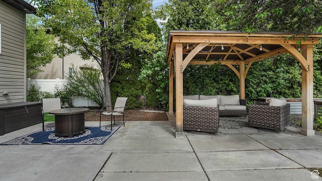 view of patio featuring an outdoor hangout area, a gazebo, and fence