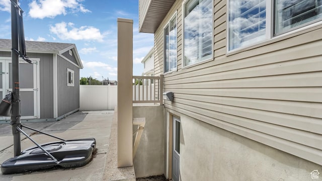 view of property exterior with fence and a patio