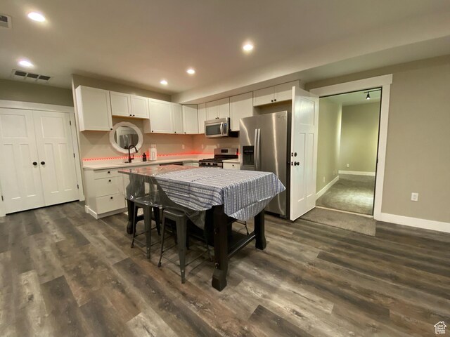9362 N Sunnyvale Dr, Eagle Mountain, UT 84005 - kitchen with stainless steel appliances, baseboards, white cabinets, dark wood-style flooring, and recessed lighting