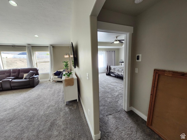 9362 N Sunnyvale Dr, Eagle Mountain, UT 84005 - hallway featuring dark carpet, arched walkways, recessed lighting, and baseboards