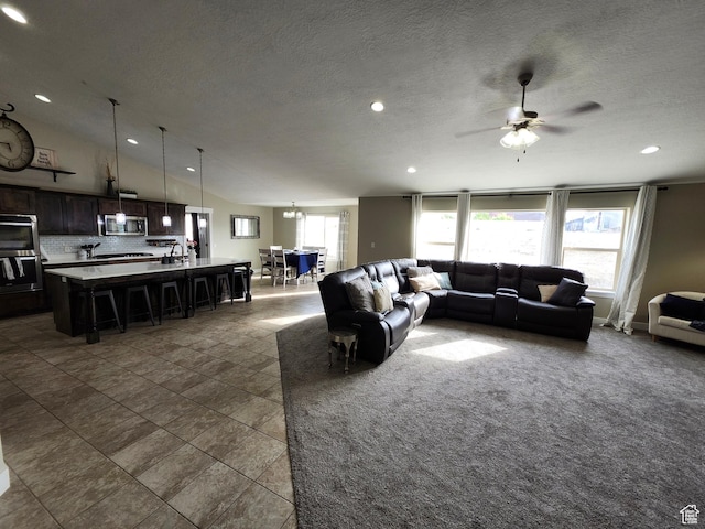 9362 N Sunnyvale Dr, Eagle Mountain, UT 84005 - living room featuring dark tile patterned floors, a ceiling fan, recessed lighting, a textured ceiling, and lofted ceiling
