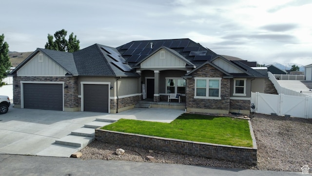 9362 N Sunnyvale Dr, Eagle Mountain, UT 84005 - craftsman inspired home with board and batten siding, a gate, a garage, covered porch, and solar panels