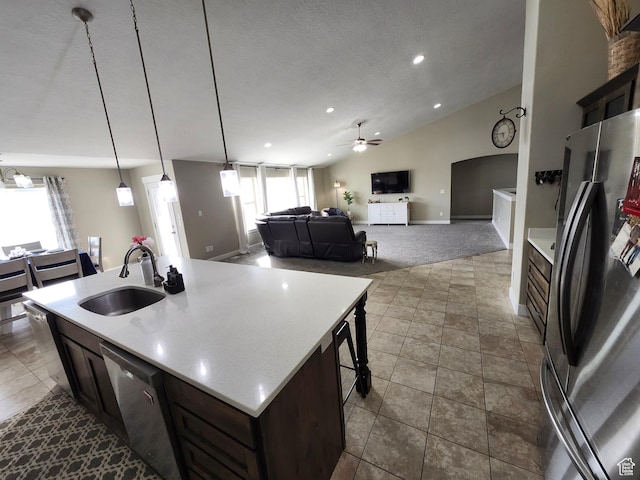 9362 N Sunnyvale Dr, Eagle Mountain, UT 84005 - kitchen featuring stainless steel appliances, a sink, ceiling fan, light countertops, and vaulted ceiling